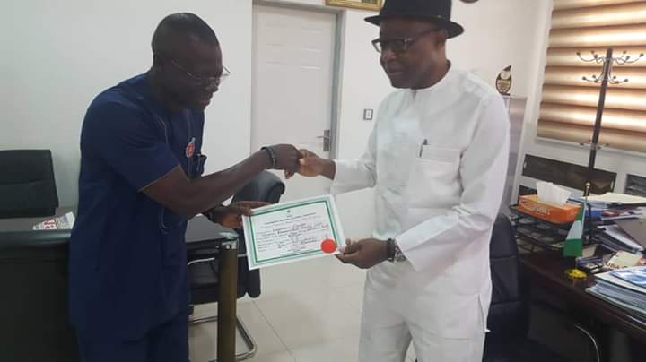 INEC national Commissioner, South-South, presenting the certificate of return to Emeka Ozegbe in Abuja