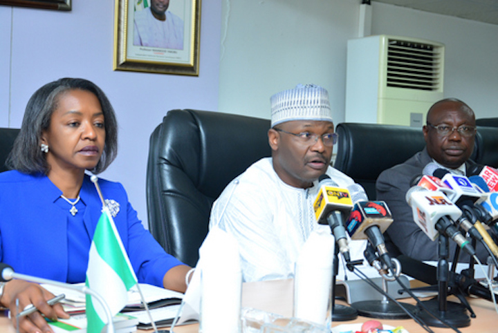 INEC Chair Mahmood Yakubu (centre) with National Commissioners, Mrs May Agbamuche-Mbu (left) and Barrister Festus Okoye (right)