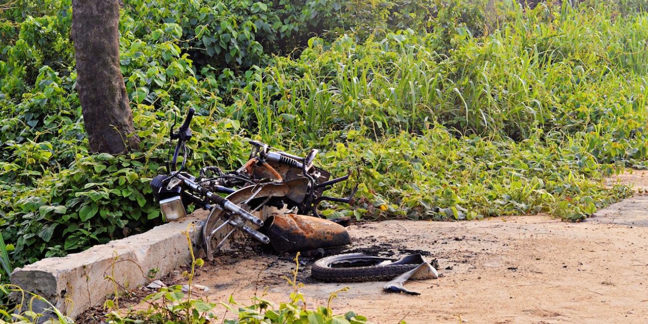 A burnt motorcycle near a gas leak opposite a farm in Ebocha