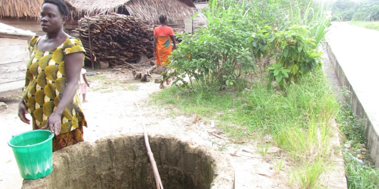 Woman leaving after fetching water from well