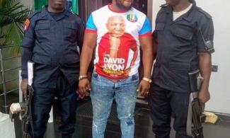 Photo Shows Arrested Notorious Kidnapper, Lion, Rocking Ruling APC Campaign T-shirt, Posing With Security Operatives 