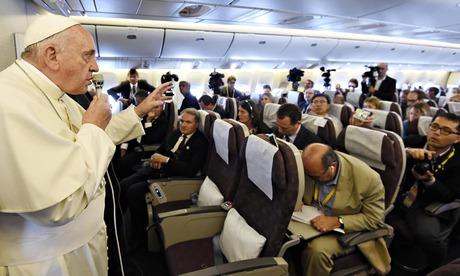 Pope Francis gestures while speaking to journalists aboard a flight from South Korea to Italy, 18 August 2014