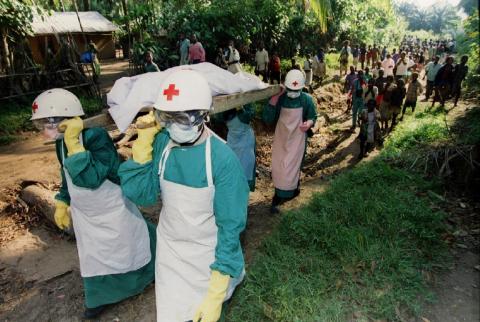 Red Cross workers carry the body of a woman who died of the Ebola virus during a 1995 outbreak in the Congo